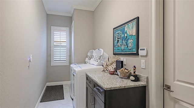 washroom featuring ornamental molding, cabinets, washing machine and dryer, and light tile patterned flooring