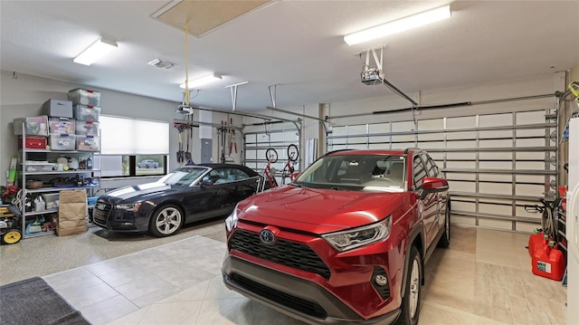 garage with electric panel and a garage door opener