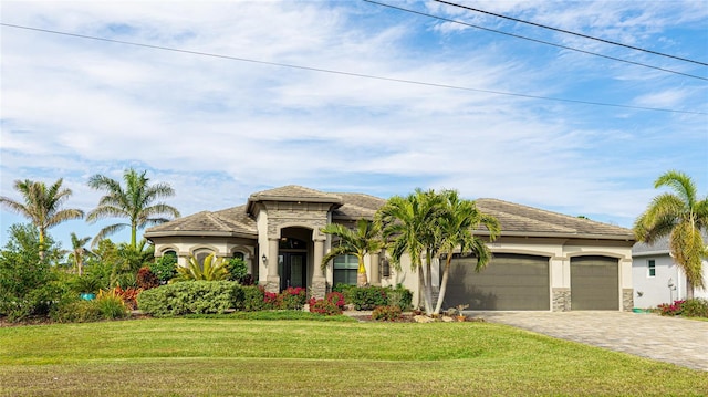 view of front of house with a garage and a front lawn