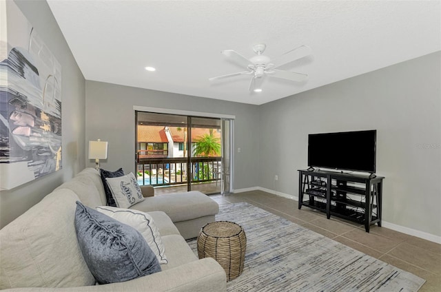 living room featuring ceiling fan and light tile patterned floors