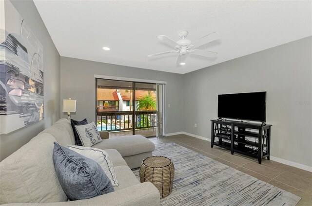 living room with ceiling fan and light tile patterned floors