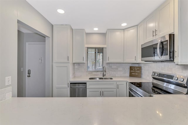 kitchen featuring white cabinets, sink, and stainless steel appliances