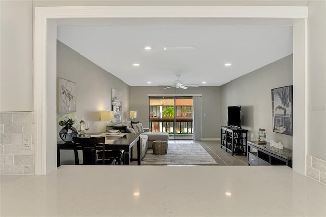 tiled living room featuring ceiling fan