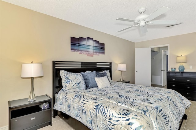 bedroom with ceiling fan and a textured ceiling