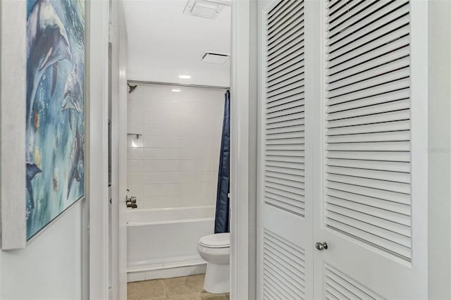 bathroom with toilet, tile patterned flooring, and shower / bath combo with shower curtain