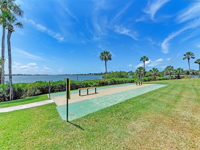 surrounding community with a water view and a yard