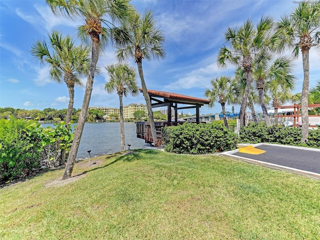 dock area featuring a gazebo, a yard, and a water view