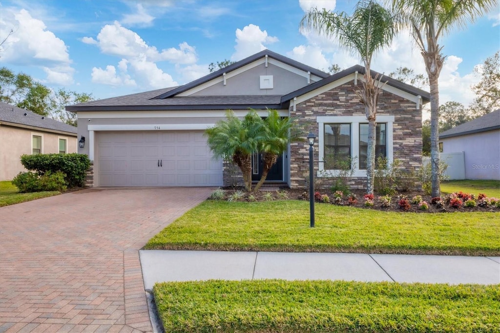 view of front of home featuring a front yard and a garage