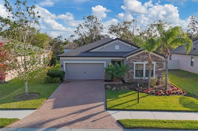 view of front of home featuring a garage and a front lawn