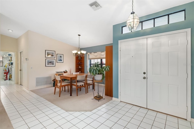 tiled entryway featuring lofted ceiling and a notable chandelier