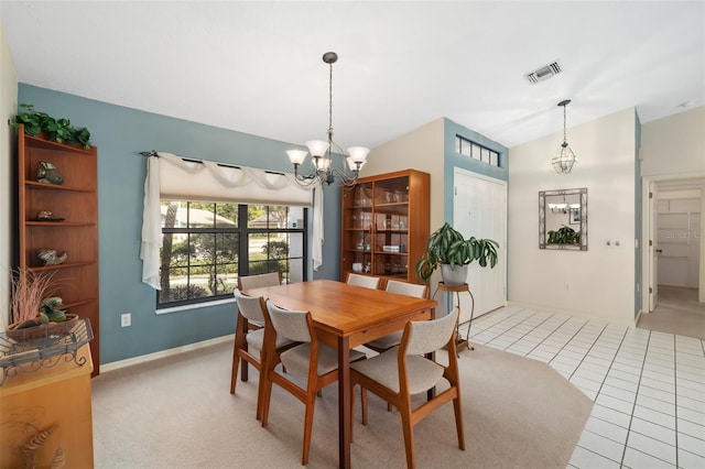 tiled dining area featuring a notable chandelier