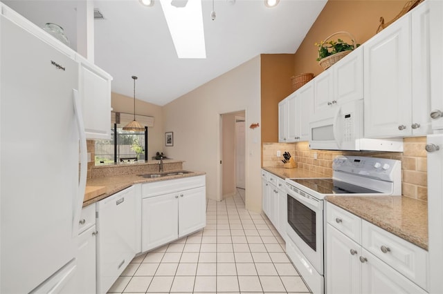 kitchen with vaulted ceiling with skylight, sink, white cabinetry, and white appliances