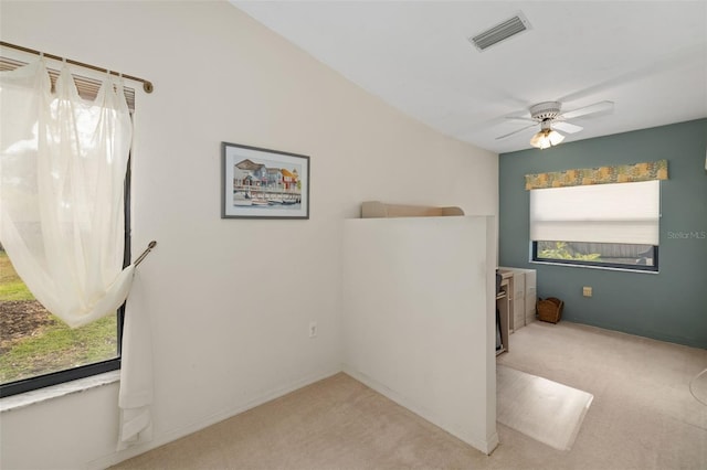 carpeted spare room featuring ceiling fan