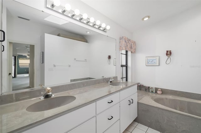 bathroom with vanity, a bathtub, plenty of natural light, and tile patterned floors