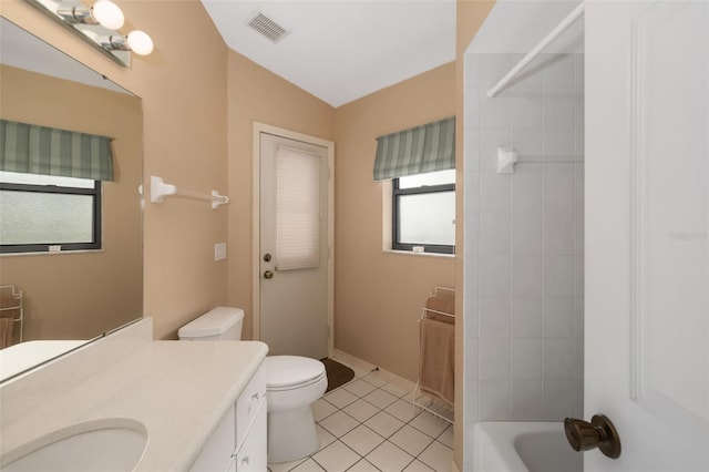 bathroom with toilet, tile patterned flooring, vaulted ceiling, and vanity