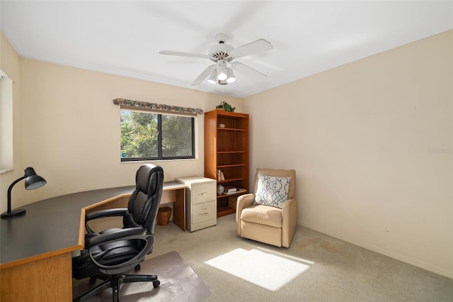 carpeted office space featuring ceiling fan