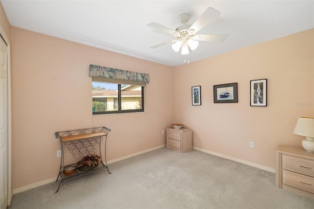 miscellaneous room featuring ceiling fan and light colored carpet