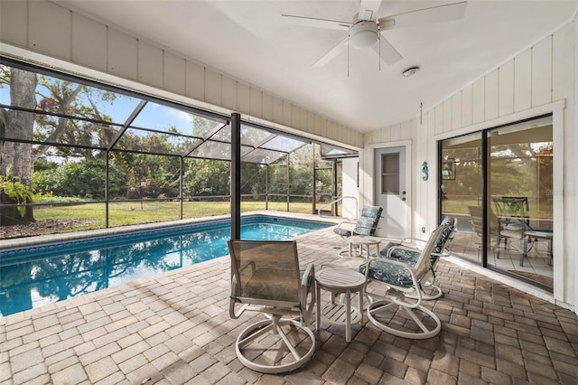 view of pool featuring ceiling fan, a lanai, and a patio area