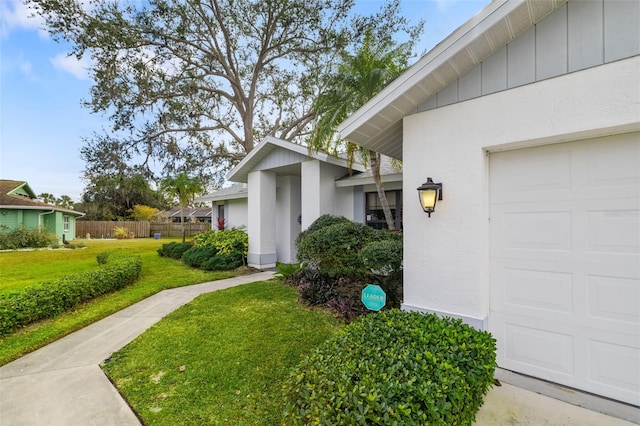 exterior space featuring a lawn and a garage