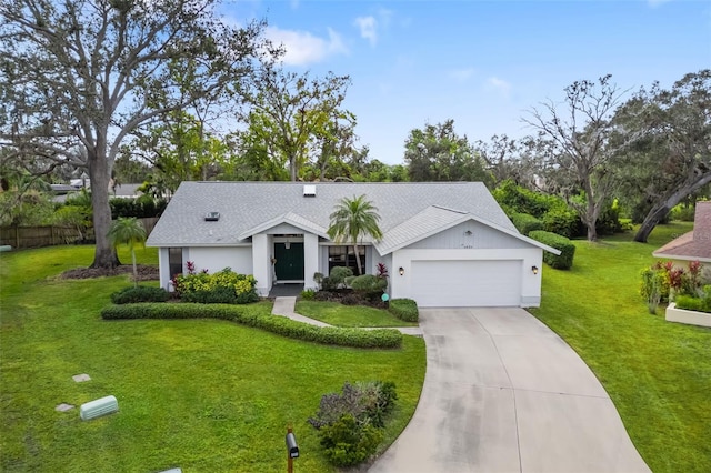 ranch-style house featuring a front yard and a garage