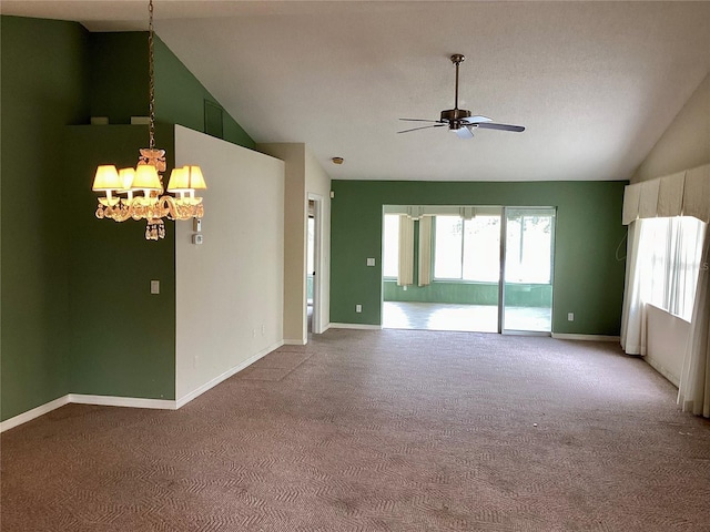 spare room featuring ceiling fan with notable chandelier, light carpet, and lofted ceiling