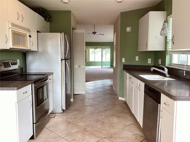 kitchen featuring sink, white cabinetry, ceiling fan, plenty of natural light, and appliances with stainless steel finishes