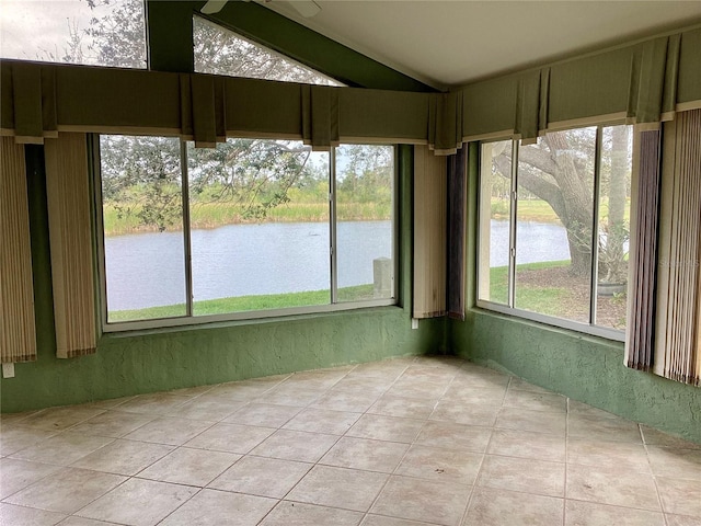 unfurnished sunroom with lofted ceiling and a water view