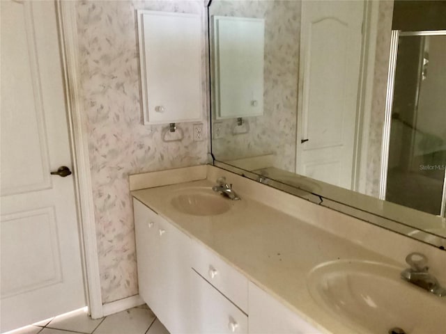 bathroom with tile patterned flooring, vanity, and a shower with shower door