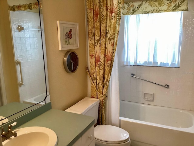 full bathroom featuring toilet, shower / bath combination with curtain, and vanity