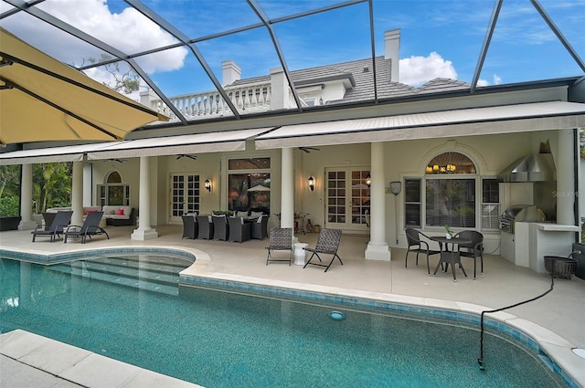 rear view of property with glass enclosure, ceiling fan, outdoor lounge area, area for grilling, and a patio