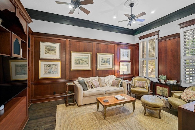 living area with ceiling fan, dark wood finished floors, and crown molding