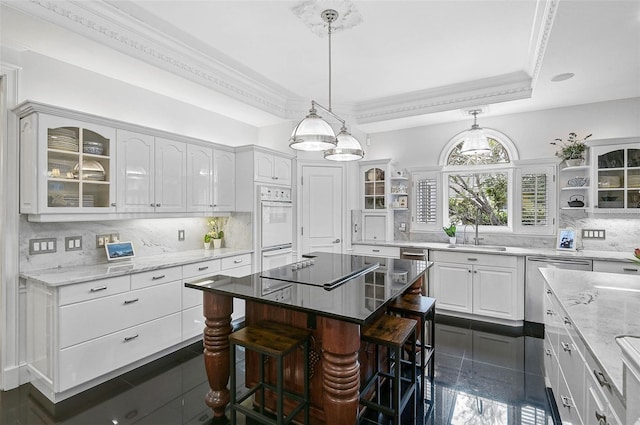 kitchen with a sink, ornamental molding, white cabinetry, and open shelves