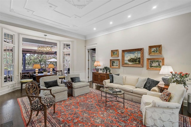 living area with a chandelier, recessed lighting, crown molding, and wood finished floors