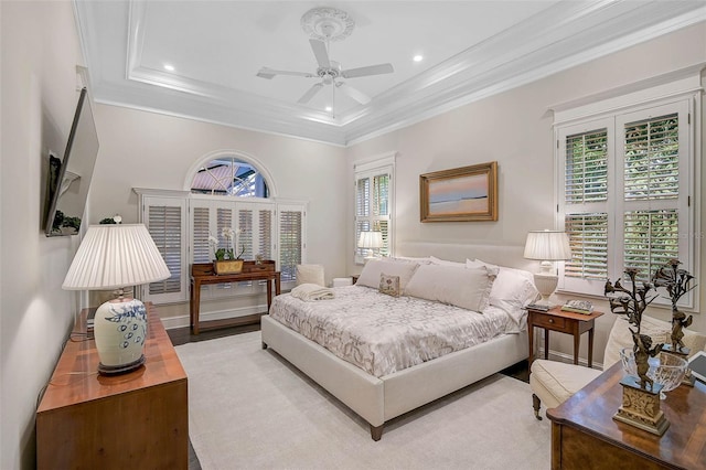 bedroom with ornamental molding, a tray ceiling, wood finished floors, recessed lighting, and ceiling fan