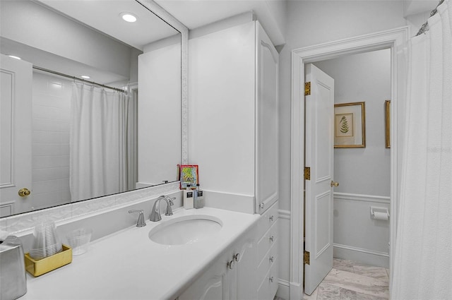 bathroom featuring recessed lighting, baseboards, marble finish floor, and vanity