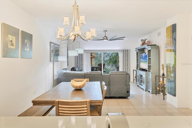 dining space featuring light tile patterned flooring and ceiling fan with notable chandelier