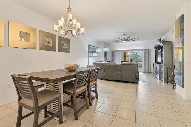 dining space with light tile patterned floors and ceiling fan with notable chandelier