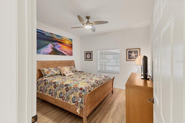 bedroom with ceiling fan and light hardwood / wood-style floors