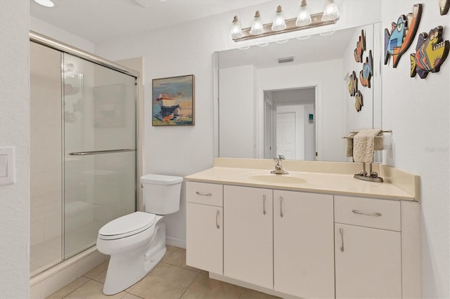 bathroom with toilet, vanity, walk in shower, and tile patterned flooring