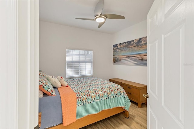 bedroom with ceiling fan and hardwood / wood-style flooring