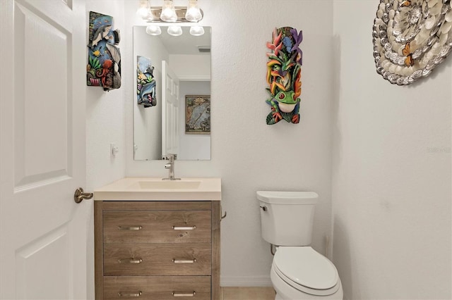 bathroom featuring toilet and vanity