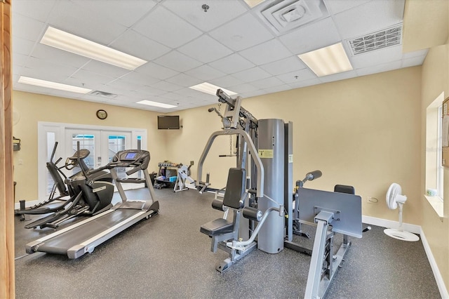 workout area with french doors and a drop ceiling