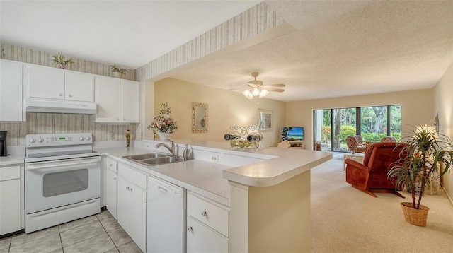 kitchen featuring white appliances, white cabinetry, sink, kitchen peninsula, and light tile patterned floors