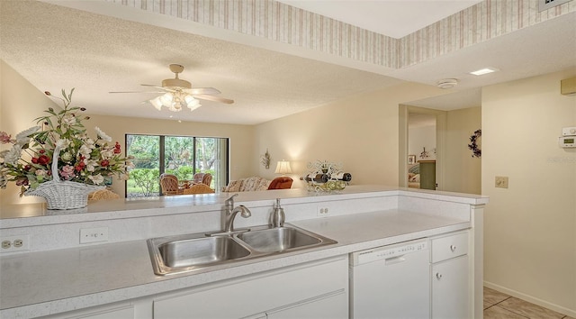 kitchen featuring light tile patterned floors, white cabinetry, white dishwasher, and sink