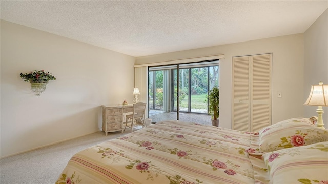 bedroom with a textured ceiling, a closet, carpet, and access to outside