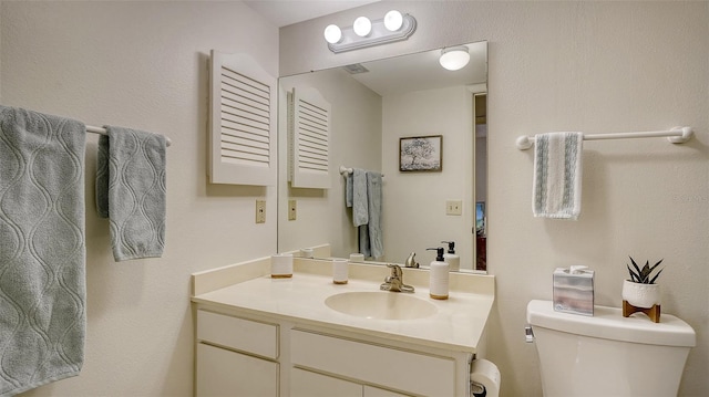 bathroom with toilet and vanity