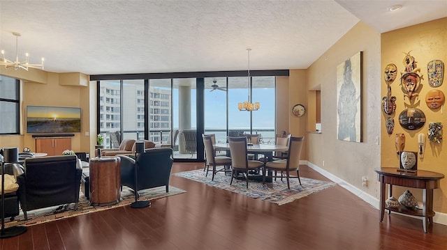 living room featuring floor to ceiling windows, dark wood-type flooring, a water view, and plenty of natural light