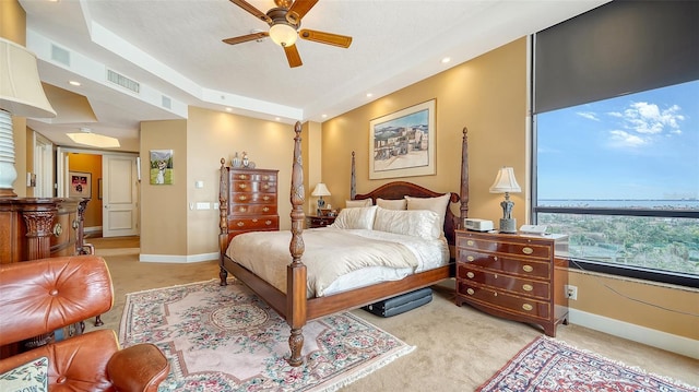 bedroom featuring light carpet and ceiling fan