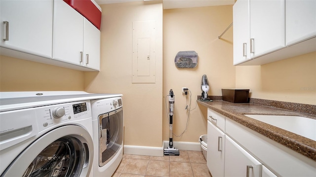 clothes washing area featuring electric panel, washer and clothes dryer, sink, and light tile patterned floors