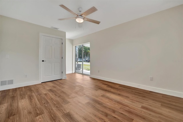 empty room with ceiling fan and light hardwood / wood-style floors